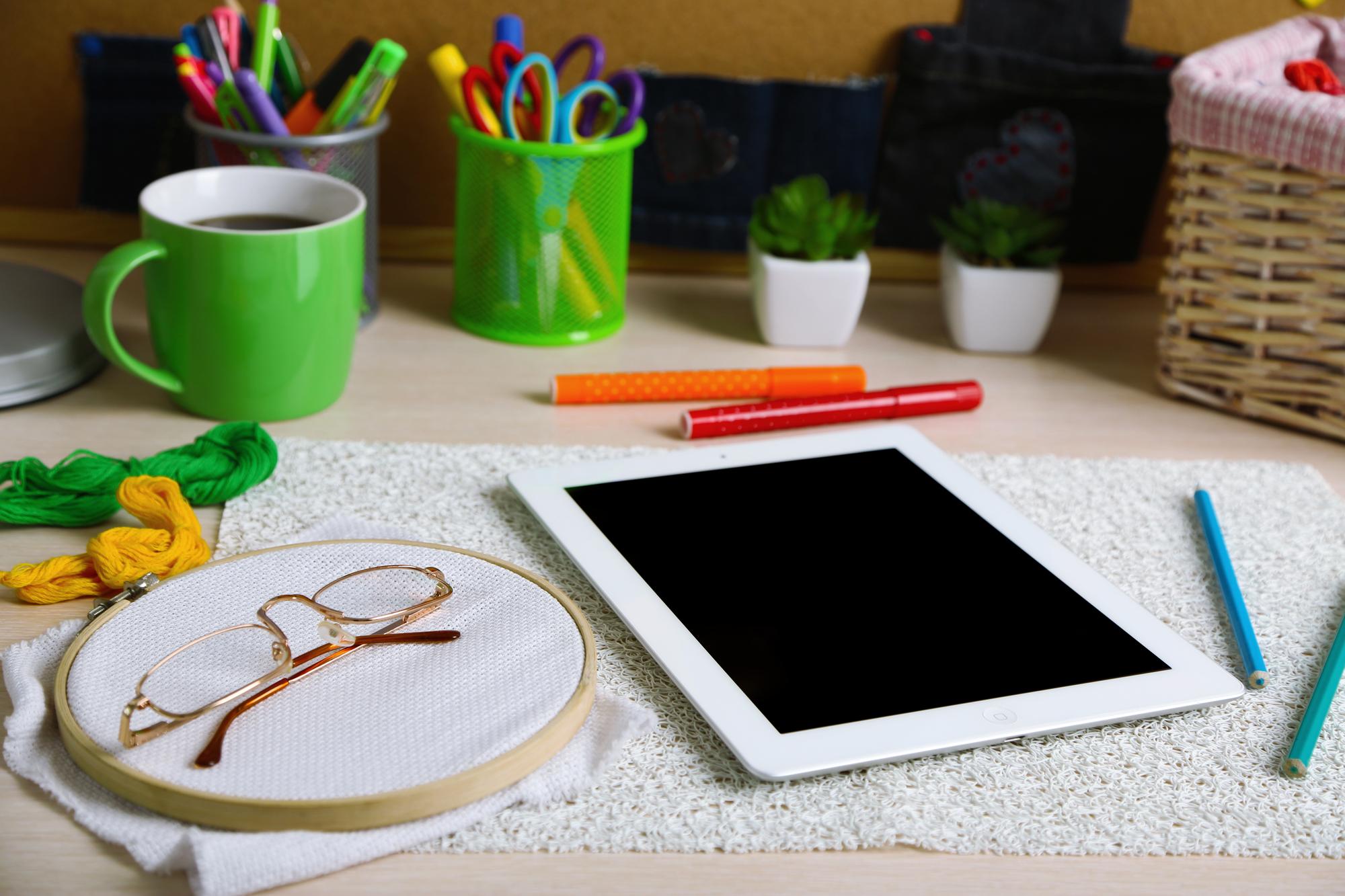 Compact studio corner with threads, needles and digital tablet